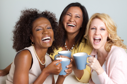 Three women holding mugs