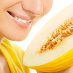 Beautiful girl with ripe melon